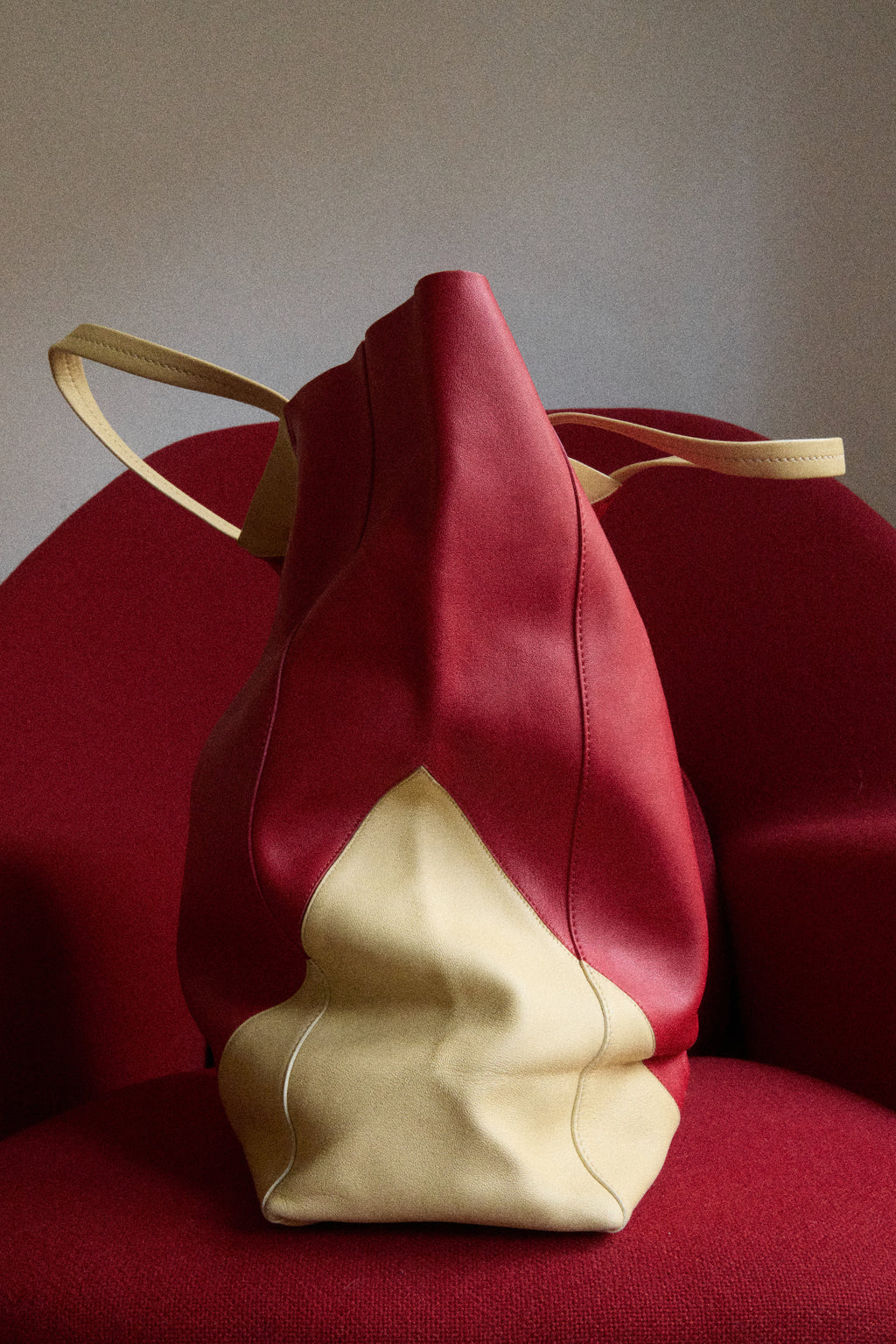 Red and beige drawstring bag on a red chair