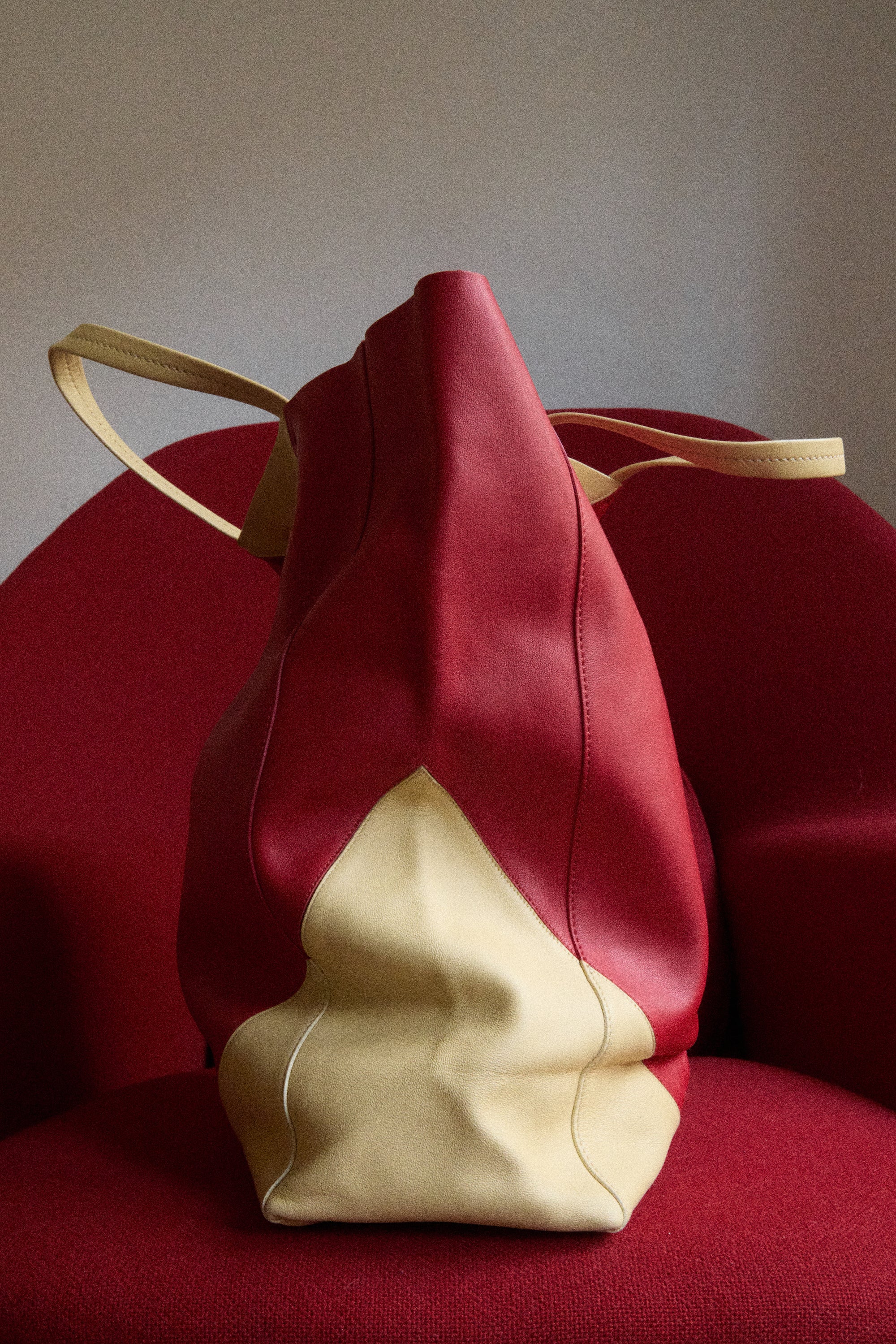 Red and beige drawstring bag on a red chair